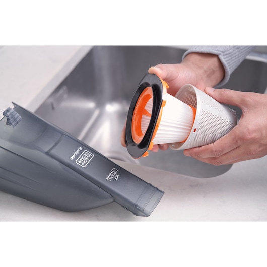 BLACKDECKER BCHV001B handheld vacuum filter being removed, shown near a sink.
