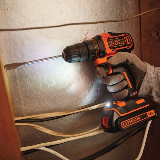Photo of a BLACK+DECKER BDCDD186KB cordless drill with 18V lithium battery used for drilling near electrical wires.