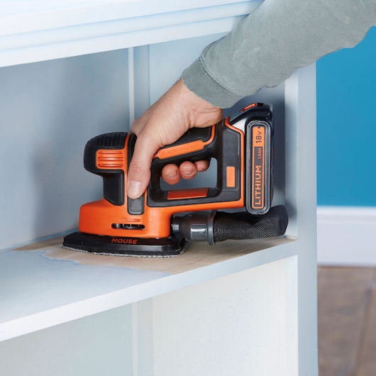 Photo of BLACKDECKER BDCDS18 cordless mouse sander in use on a wooden surface.