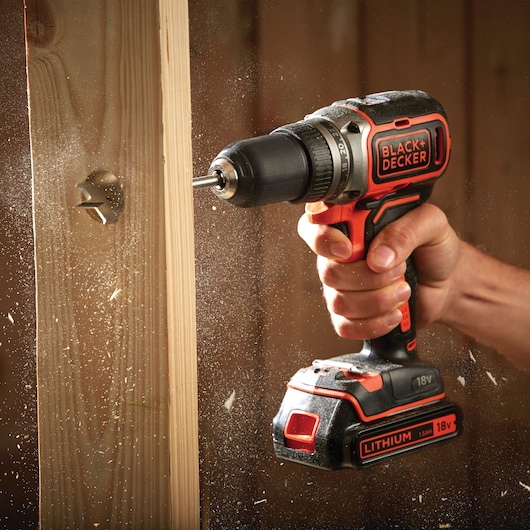 BLACK+DECKER BL186KB cordless drill used on wood, 18V lithium battery, close-up action shot.