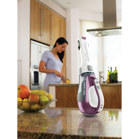 BLACKDECKER DV9610ECN handheld vacuum with purple and white casing on a kitchen countertop.