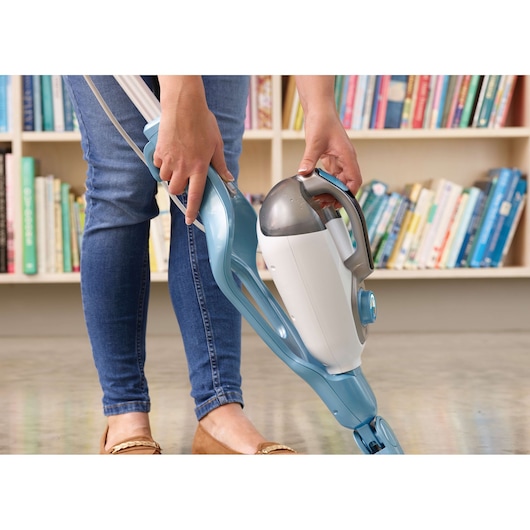 Photo of BLACKDECKER FSMH13101SM steam mop in use on floor, blue and white design, person holding handle.