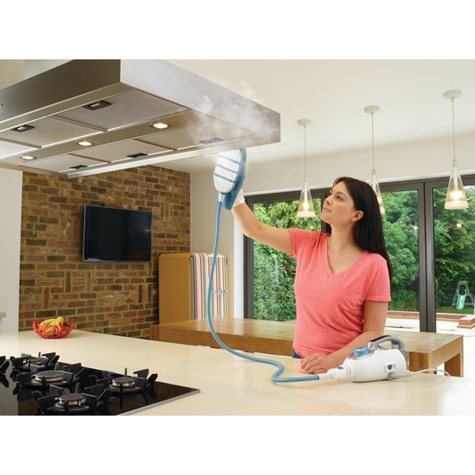 BLACKDECKER FSMH13151SM steam cleaner used on kitchen hood in modern kitchen setting.