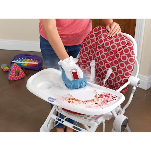 BLACKDECKER FSMH1351SM steam cleaning glove cleaning high chair tray with food stains, in a home kitchen.