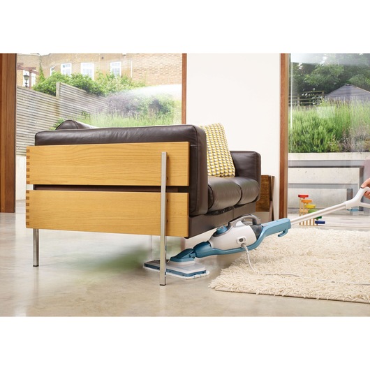 BLACKDECKER FSMH1351SM steam mop cleaning under sofa on polished floor, home setting, product in use.