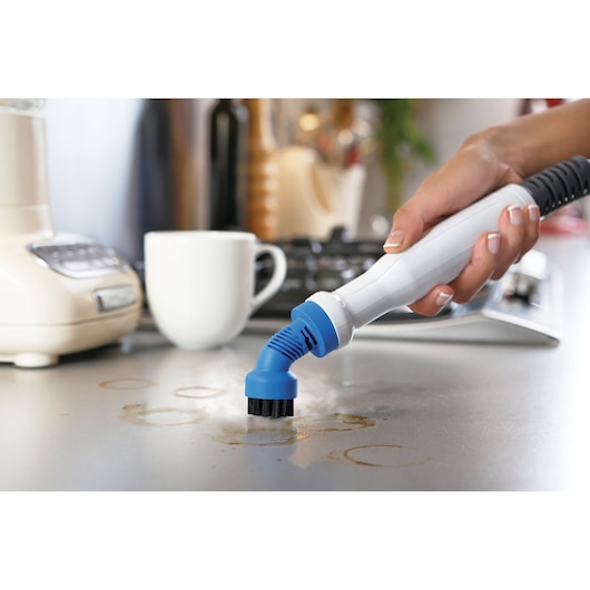 BLACKDECKER FSMHBA steam cleaner handheld brush cleaning stained kitchen counter.