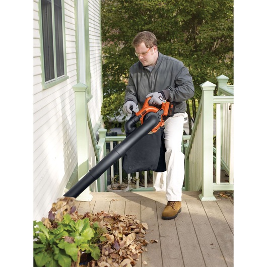 BLACKDECKER GWC3600L20 cordless leaf blower and vacuum in use on outdoor steps.