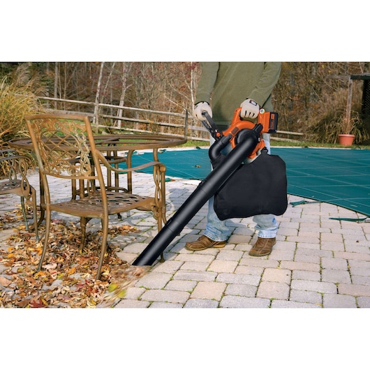 Photo of BLACKDECKER GWC3600L20 leaf blower vacuum in use cleaning leaves on patio.