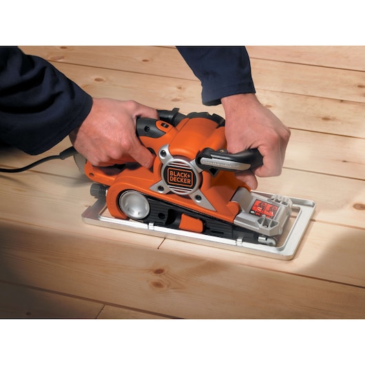 Photo of BLACKDECKER KA89EK belt sander in use on light wood flooring.