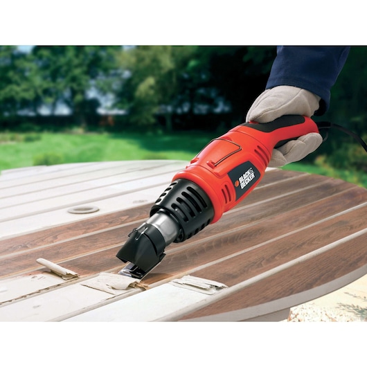 BLACKDECKER KX1692 heat gun stripping paint from wooden table outdoors.