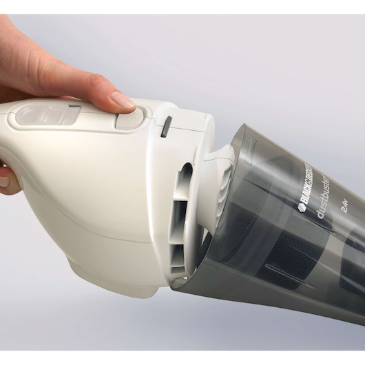 BLACK+DECKER NV2410N handheld vacuum cleaner side angle, person pressing button to detach dustbin.