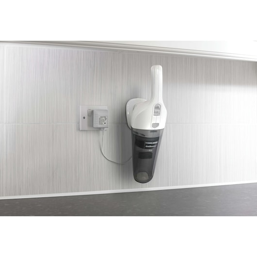 BLACK+DECKER NV2410N handheld vacuum mounted on a wall charging station, side view.