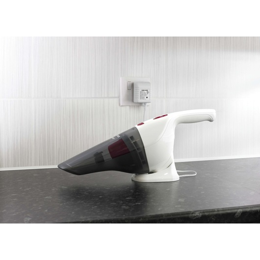 Photo of BLACKDECKER NV3610N handheld vacuum cleaner in white and black on a countertop, side view.