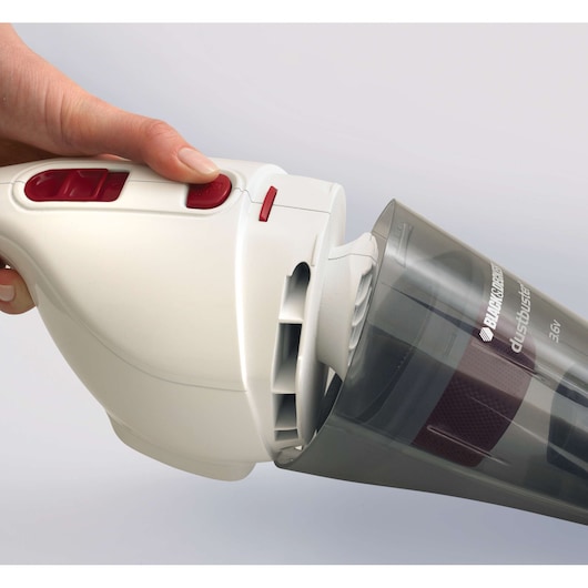 Photo of BLACK+DECKER NV3620N handheld vacuum showing dust container removal, white and gray design with red buttons.