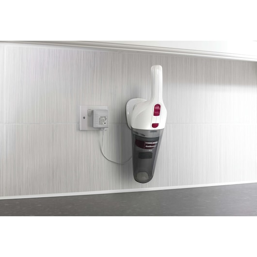 Photo of BLACKDECKER NV3620N handheld vacuum cleaner charging on wall-mounted dock, front angle.