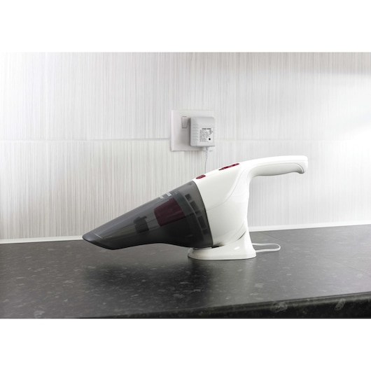 BLACKDECKER NV3620N handheld vacuum cleaner on charging base, side view on a kitchen counter.