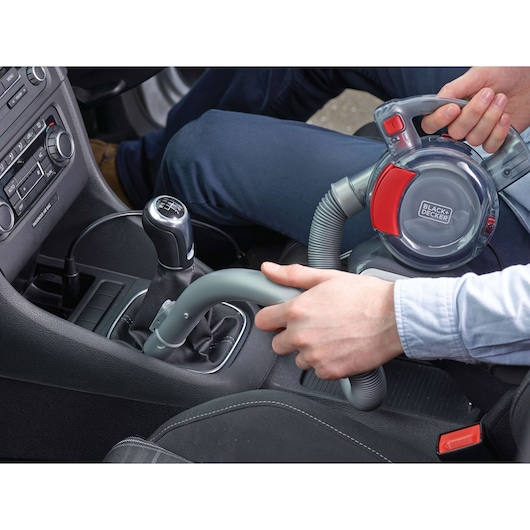 Photo of BLACK+DECKER PD1200AV handheld car vacuum with flexible hose cleaning a car interior.