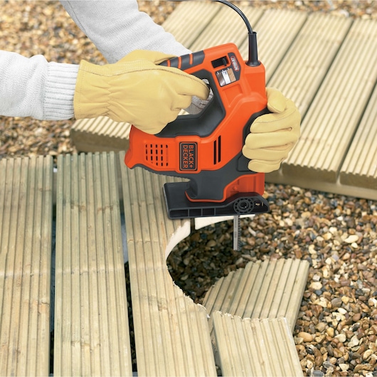 BLACKDECKER RS890K jigsaw cutting wood decking, person wearing yellow gloves.