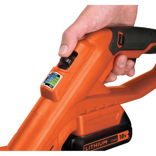 Close-up photo of BLACKDECKER STC1820 cordless grass trimmer handle with control switch and 18V lithium battery.