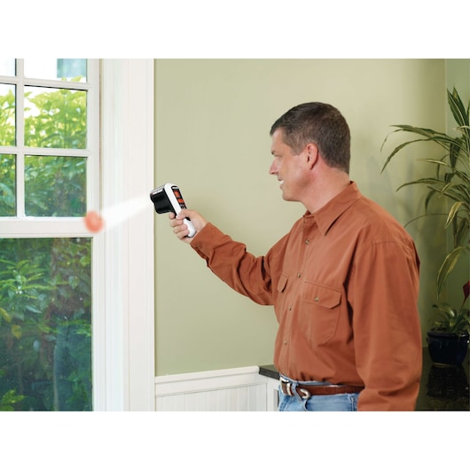 BLACKDECKER TLD100 thermal leak detector in use near a window, detecting temperature changes indoors.